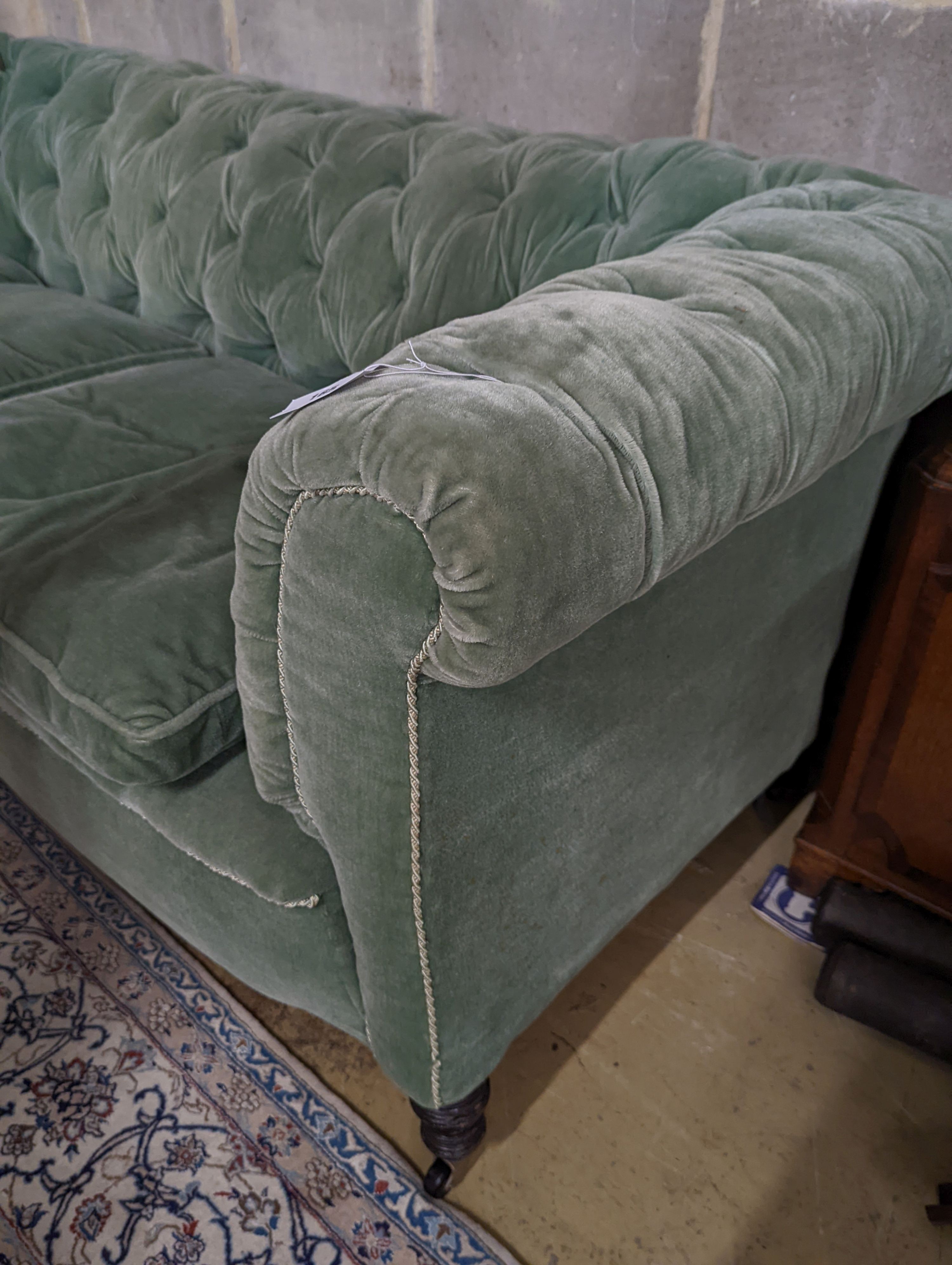 A late Victorian Chesterfield settee upholstered in buttoned green fabric, length 194cm, depth 80cm, height 76cm